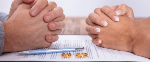 Image Shows: man and woman signing divorce papers