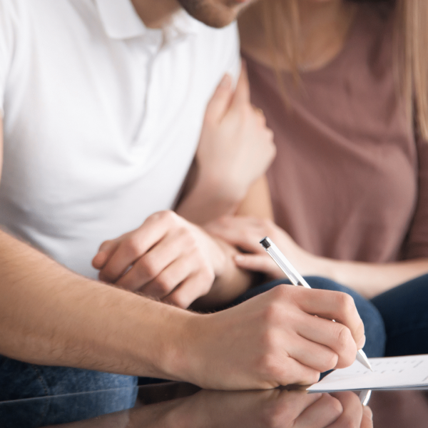 Image Shows: Couple signing document