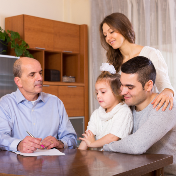 Image Shows: family signing documents