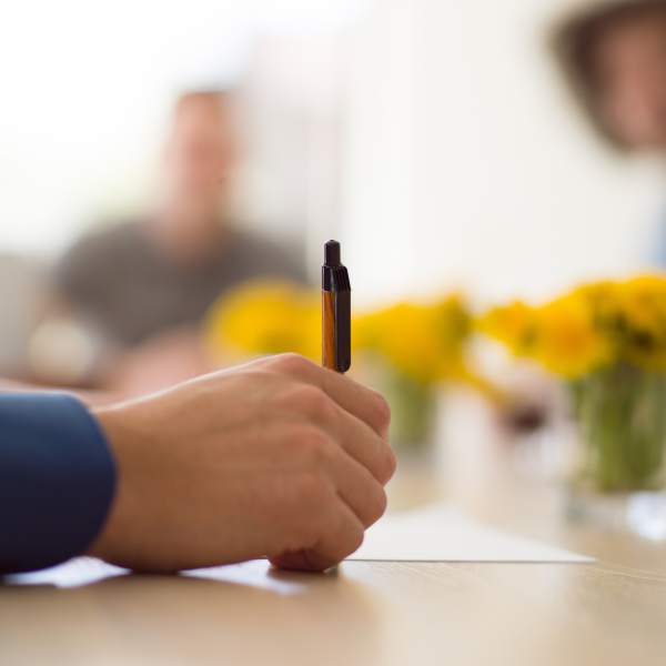 Image Shows: a man signing papers