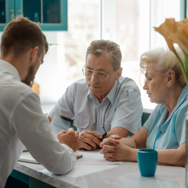 Image Shows: elderly couple speaking to lawyer