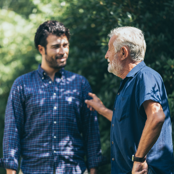 Image Shows: two men talking. A dad and son