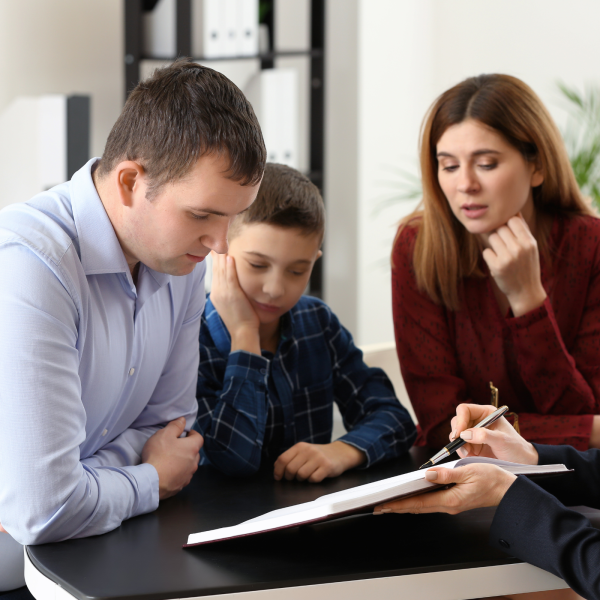Image Shows: young family looking at a document