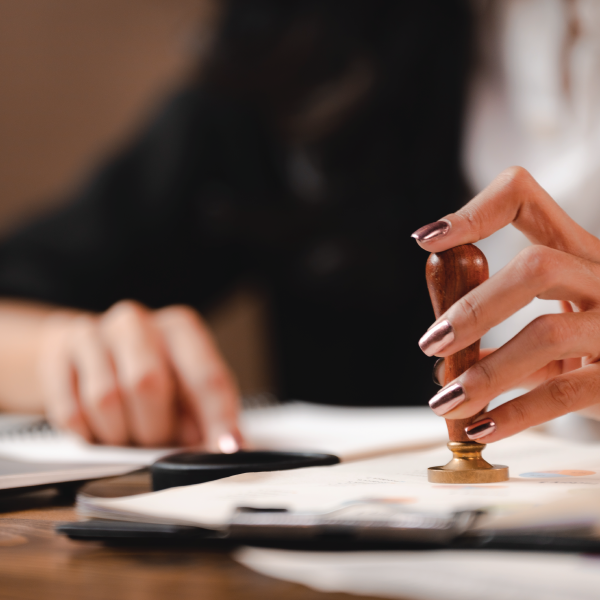 Image Shows: woman stamping page - Notary Public
