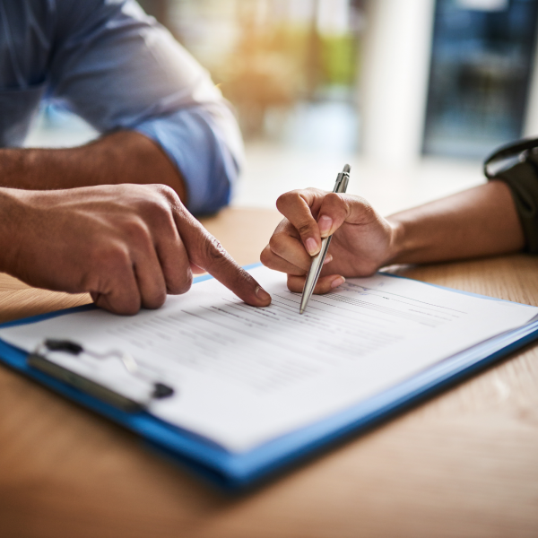 Image Shows: two people looking at papers