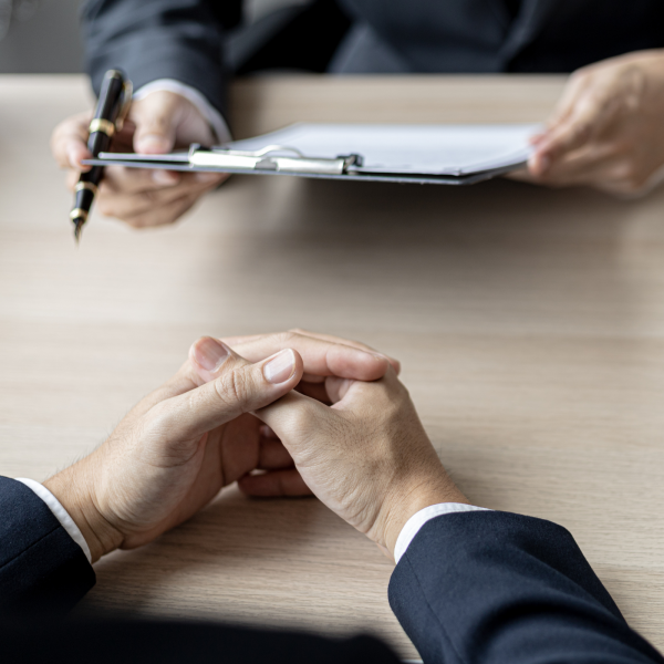 Image Shows: hands of people talking at the table