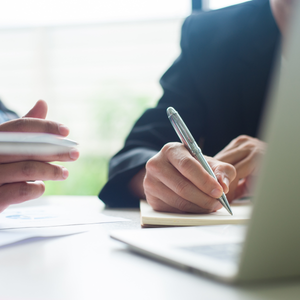 Image Shows: two people talking at desk