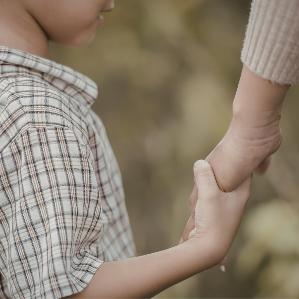 Image Shows: child holding an adults hand