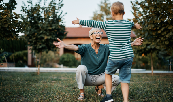 image shows grandparent hugging a grandchild