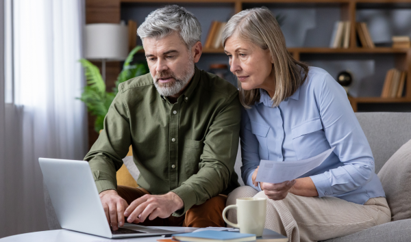 Image shows two people on a laptop confirming documents such as a will