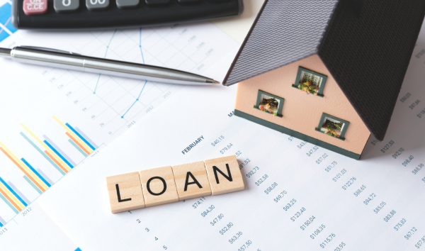 image shows the word 'loan' next to paperwork and a house