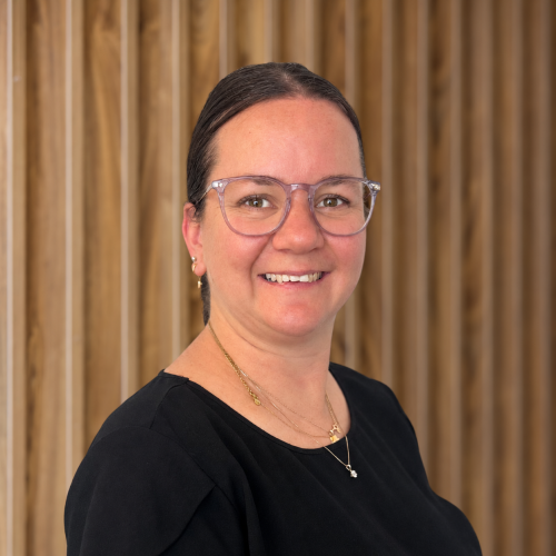 female in a black top, wooden background