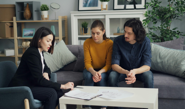 image shows couple sitting down with lawyer discussing will