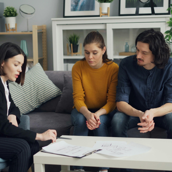 image shows couple sitting down with lawyer discussing will