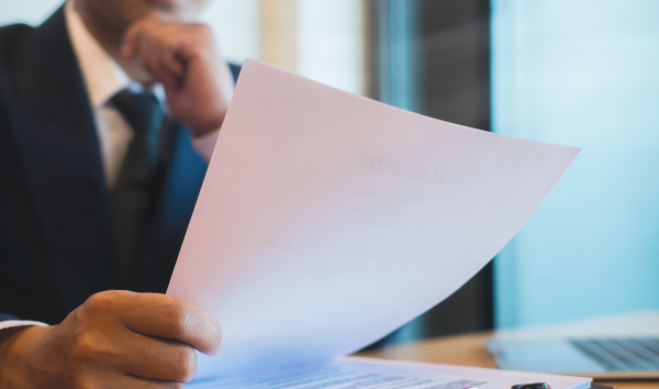 Image shows person looking through documents